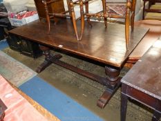 A heavy dark Oak Refectory type Dining Table standing on heavy turned and carved supports united by