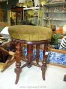 An Edwardian Mahogany screw pillar Piano Stool on four turned legs.