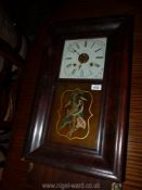 An American 'Ogive' wall clock with bird motif to the glass, the movement striking on a gong.