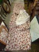 A pair of lined red floral curtains on cream ground, approx. 9' drop x 122" wide.