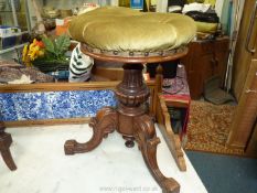 An adjustable Victorian Mahogany Piano Stool on carved tripod base.