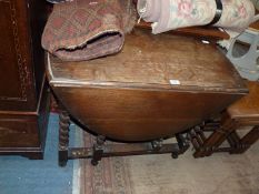 A dark oak drop-leaf gateleg Table having twist central section to the legs,