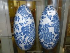 A pair of blue and white crackle glaze oriental egg shaped ornaments, 10'' tall..
