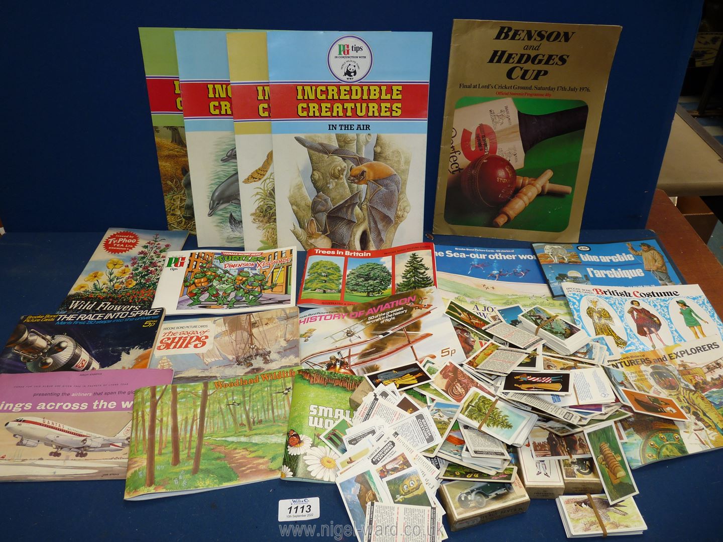 A box of cigarette and tea cards, books and posters.