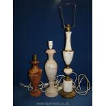 Three Onyx table lamps including pale pink, marble brown and one with metal detail.