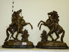 A pair of cast metal/spelter 'The Horses of Marley' figures of man taming a rearing horse,