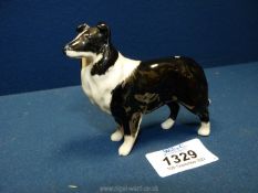 A small Beswick standing Collie dog figure.