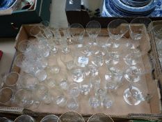 A quantity of cut glass including seven wine glasses in unique slant shape with diagonal engraving