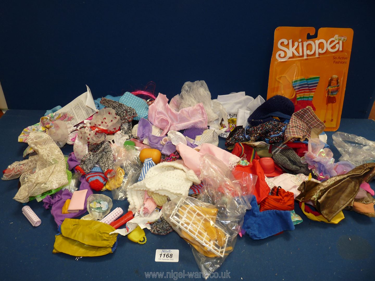 A quantity of doll's clothes including Barbie and a Barbie skipper clothes set.