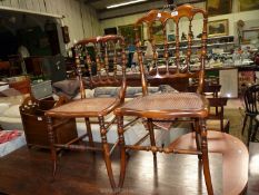 Two Satinwood framed Side Chairs having caned seats, turned swept front legs and stretchers,