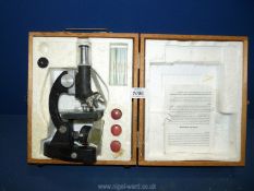 A boxed Microscope with glass slides.