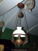 A large ceiling hanging oil Lamp converted to electric having Art Deco design with a white glass