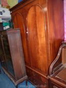 A flame mahogany double Wardrobe, the upper portion with a hat shelf and hanging rail,