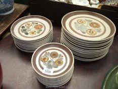 A quantity of Langley pottery plates with brown rim and decorated with stylised flowers including