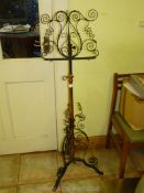 A wrought iron metal music stand with copper column, 49'' tall overall.