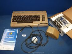 A Commadore 64 with user manual and a boxed Commodore 1530 Datassette unit model C2N.