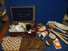 A small suitcase of upholstery tools including tacks, needles, hooked needles, mallet, hammers,