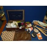 A small suitcase of upholstery tools including tacks, needles, hooked needles, mallet, hammers,