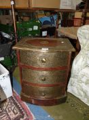 A small Mahogany three-drawer bow front chest of three drawers with embossed brass overlay,