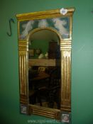 A gilt wall mirror with column surround.