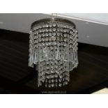 A two tier brass and drop crystal light fitting, 8" diameter.