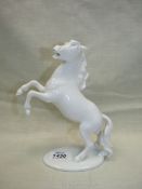 A white porcelain rearing horse by Kaiser of Germany.