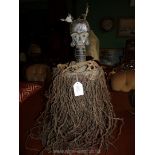 A tribal Art Kota Mahongwe reliquary figure with basket, having patinated copper sheathing,