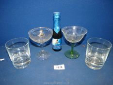 A bottle of Babycham, with Babycham glass, plus two Bells whisky glasses.