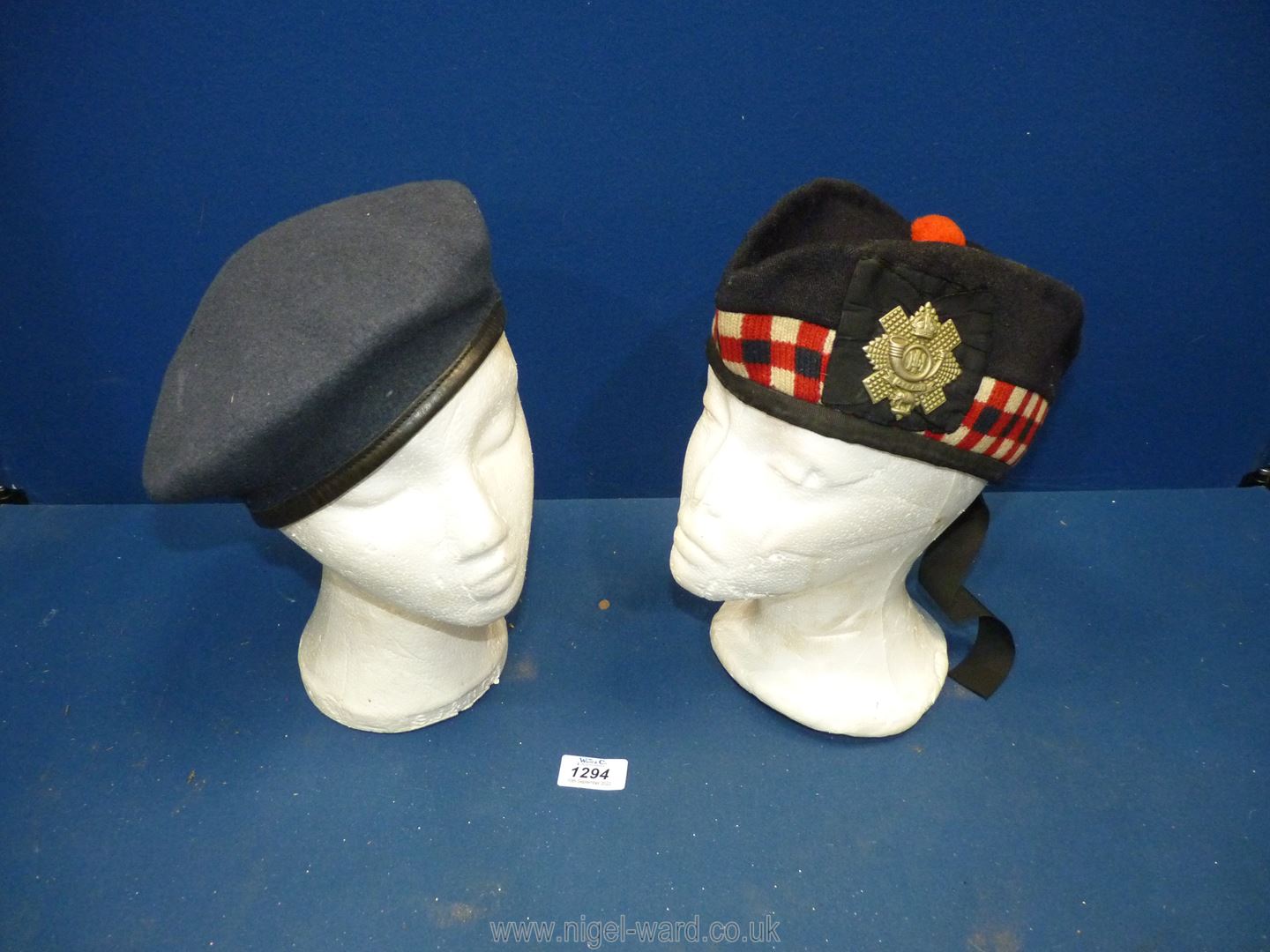 A 1944 Scottish military cap, plus a navy blue felt beret.