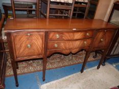 A contemporary serpentine fronted crossbanded Mahogany Sideboard having a pair of central drawers