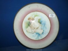 A framed and glazed circular Plaque of cherub.