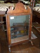 An attractive Georgian Walnut and Mahogany swing Mirror, 22'' tall.