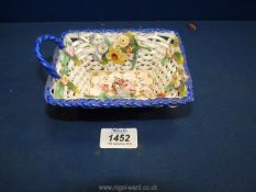 An unusual porcelain Basket wtih floral decoration, possibly Coalport, (one handle missing).