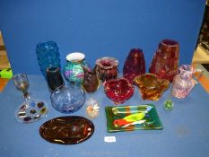 A large quantity of coloured glasses to include cranberry vases, Swedish amber coloured plaque,