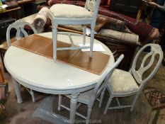 A grey painted finish Dining Suite comprising a circular dining table on turned and fluted legs,