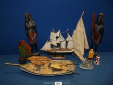 Two African wooden carvings and two wooden boats.