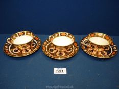 Three Royal Crown Derby teacups and saucers, in Imari colours, cup pattern no. 6149.