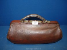 A brown leather Gladstone Bag