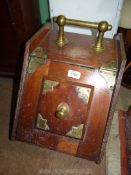 A Mahogany coal box with brass handle and decoration.