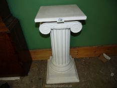 A plaster column/pillar/pedestal having an Ionian capital, 23" tall x 13" diameter.