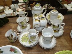 A quantity of Denby Troubadour pottery including 11 tea cups, 10 matching saucers, a coffee cup,