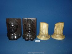 A pair of well carved heavy ebony bookends in the form of an African male and female (7" tall),