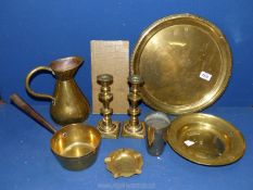 A quantity of brass including trays, jug , candlesticks with pushers, beaker etc.