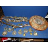 A quantity of horse brasses including brass calendar surrounded by signs of the zodiac on wooden