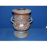 A two handled urn style vase with embossed mask head detail, etc.