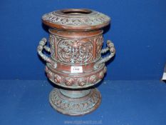 A two handled urn style vase with embossed mask head detail, etc.