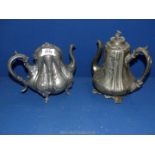 Two old Pewter teapots on feet, with hinged lids.