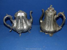 Two old Pewter teapots on feet, with hinged lids.