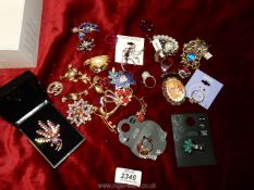 A quantity of brooches and rings, some new.