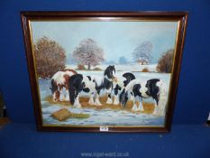 A framed Oil on board depicting Horses in the snow eating hay, signed lower right Yvonne Garner,